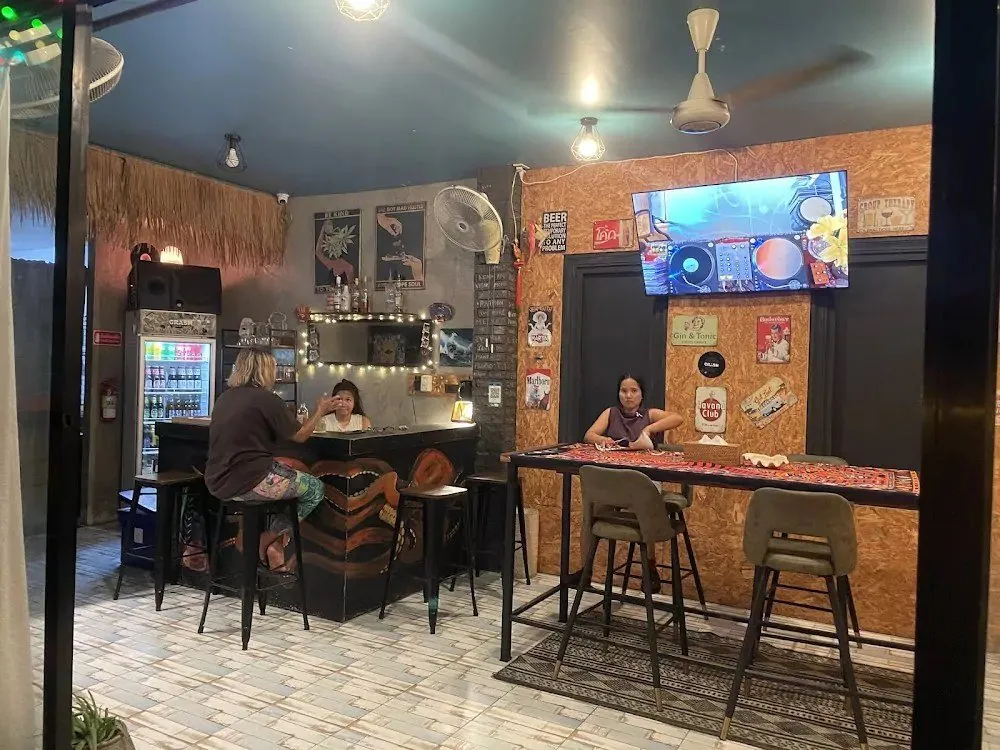 Inside the bar with stools and a TV