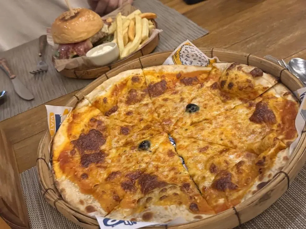 Pizza, burger and fries on a table at Crash