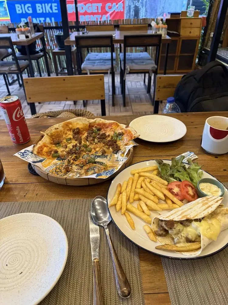 Pizza, fries and a chicken wrap with salad